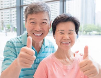 old couple smile and show thumb up to you